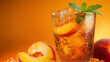 © si9nzation - Peach iced tea with fresh mint leaves and ice cubes served in glasses.