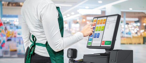 Touch screen point of sale system or cash register machine on desk with finger point