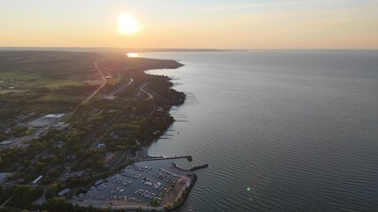 Wall Mural - Aerial footage of Thornbury Municipal Harbor and the nearby coastal buildings at sunset