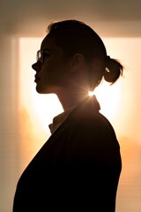 Canvas Print - Professional woman in silhouette against a bright background.