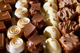 Assorted chocolate and creamy desserts with intricate designs arranged on a tray