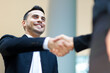 © Minerva Studio - Professional handshake closeup with smiling businessman