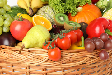 Wall Mural - Different fresh fruits and vegetables in wicker basket, closeup