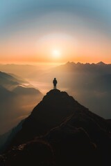 Sticker - Silhouette of a person standing on top of a mountain.