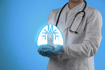 Wall Mural - Doctor holding virtual lungs on light blue background, closeup