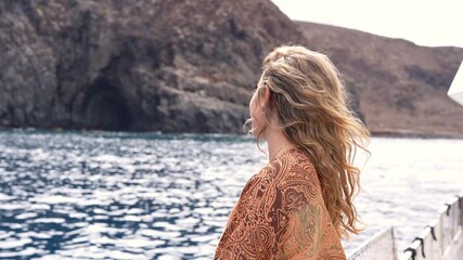 Wall Mural - One young blonde and beautiful young woman looking and enjoying summer days in vacation holiday having fun in catamaran boat sailing in the water of sea
