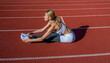 © Yevhen - Athletic woman working out on track. Conception of fitness. Young woman in sportive clothes is exercising outdoors. Sports exercises and stretching in the stadium. Physical training girl