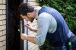 © Vitaliy - Close-up shot of a concentrated craftsman fixing a door