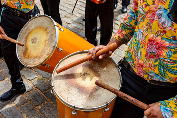 Drummers and their instruments performing during a typical street party in Brazil