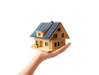 © zphoto83 - A hand holding a model house with solar panels in bright light