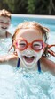 © volga - Cheerful girl swimming with goggles in sunny pool