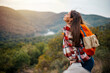 © Dragana Gordic - Young woman breathing pure air in a forest. Young woman hiking and going camping in nature. Person with backpack walking in the forest. Trekker breathing fresh air in the top of a mountain