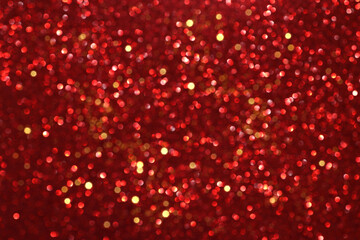 Wall Mural - Red glitter bokeh background with sparkling light, abstract defocused texture. Holiday lights.