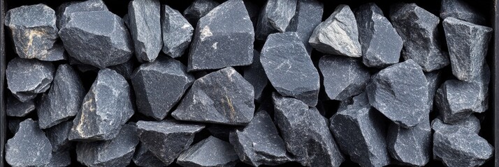 Aufkleber - A collection of irregular gray stones organized in a wooden box, suitable for decorative landscaping and construction projects