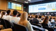 © keetazalay - A lively group of university students participating in a data-driven learning session in a modern lecture hall, with screens displaying real-time data and interactive charts, showcasing the