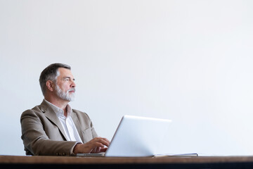 Sticker - Portrait of mature man sitting at his desk in the modern office.