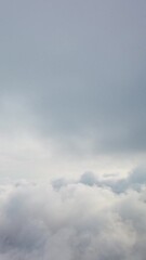 Wall Mural - aerial vertical view over foggy and fluffy clouds. blue sky sun, sea fog. abstract nature summer oce