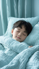 Sticker - A young boy is sleeping on a bed with a blue blanket