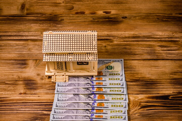 Wall Mural - Plywood model of the house and one hundred dollar banknotes. Loan, real estate concept