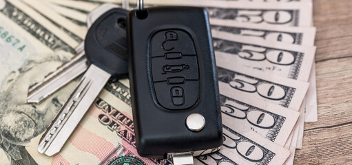 Poster - black car key on dollar paper money on desk