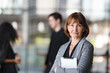 © DG PhotoStock - Diverse businesspeople are standing at the building corridor and talking together.