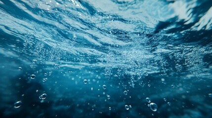 Wall Mural - Underwater view showcasing bubbles rising in crystal-clear water, creating a tranquil and immersive blue atmosphere.