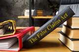 The False Claims Act FCA near the book and folders.