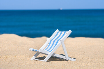 Wall Mural - Empty sun lounger at a sandy beach