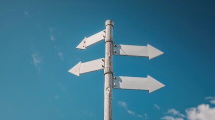 4 way arrow white signpost pole with blur sky cloud