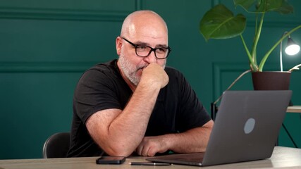 A professional male programmer brainstorms in a modern office. Perfect for themes of innovation, tech development, and collaborative problem-solving.
