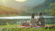 © Denisa - A couple shares drinks on a cozy blanket by a calm lake surrounded by mountains as the sun sets