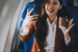 © ARMMY PICCA - .Asian woman looking at phone while sitting on airplane Technology female travelers using mobile smartphones, online apps, and the internet while sitting in airplane seats during travel.