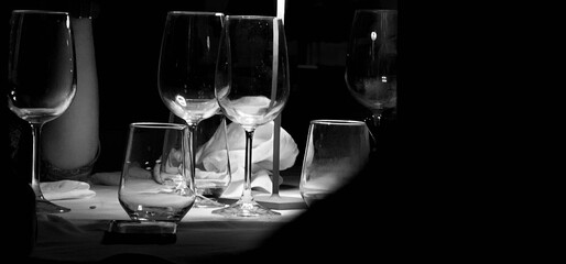 crystal glass glasses on a restaurant table set for dinner on a summer evening