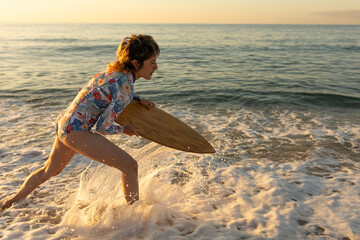 A woman is running in the ocean with a surfboard. The water is choppy and the sky is a mix of blue and orange