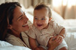 © nenetus - Mother and Baby Laughing Together On the Bed
