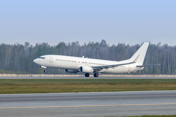 Modern white passenger airliner takes off runway