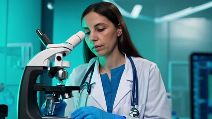 Poster - This Scientist examines samples carefully with a microscope in a laboratory.