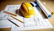 © Mahnoor - Blueprint floor plan architectural project on the table with yellow helmet and pencil