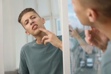 Sticker - Man touching his face near mirror indoors