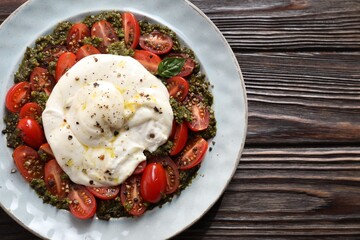 Wall Mural - Fresh delicious burrata salad on wooden table, top view. Space for text