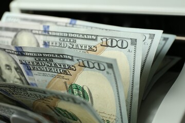 Wall Mural - Money counter machine with dollar banknotes, closeup