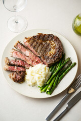 Canvas Print - ribeye steak with asparagus and mushed potato