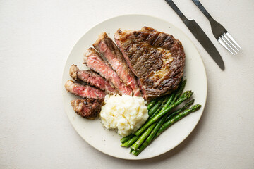 Canvas Print - ribeye steak with asparagus and mushed potato