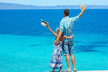 Canvas Print - A happy father with a child near the sea in nature weekend travel