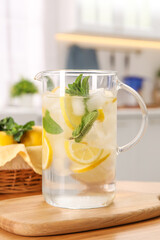 Canvas Print - Freshly made lemonade with mint in jug on wooden table indoors