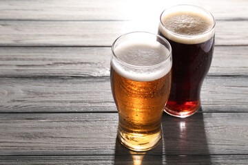 Poster - Glasses with different types of beer on grey wooden table, space for text