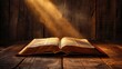© FryArt - Glowing open bible on wooden table with ray of light streaming through