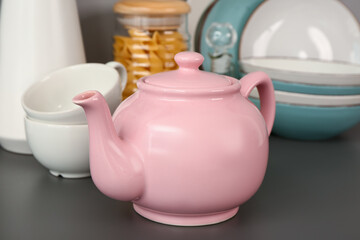 Poster - Composition with teapot, cups and different kitchen stuff on black table