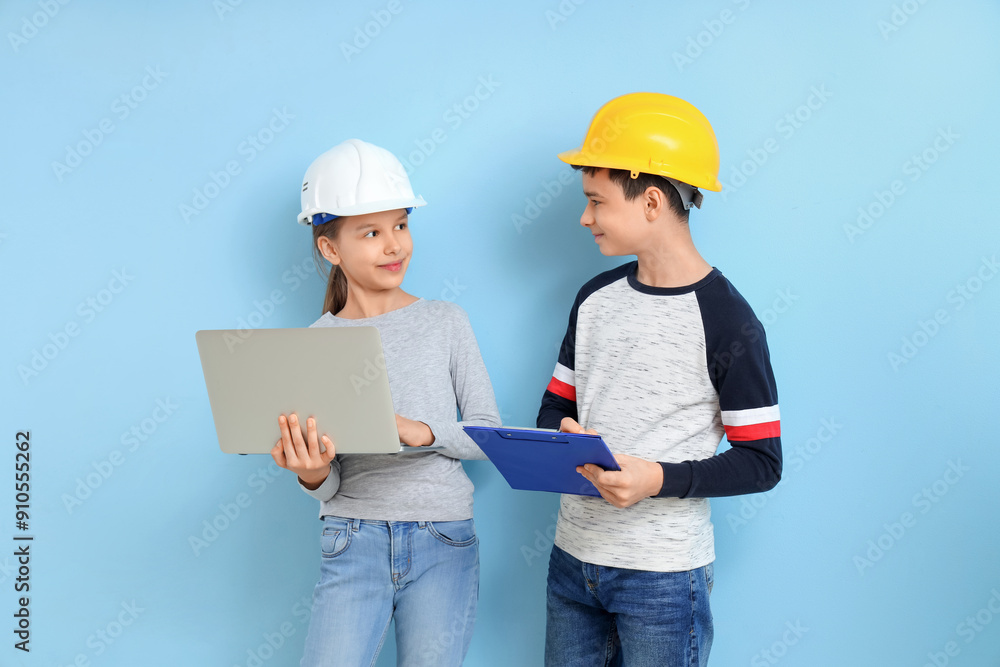 Little architects with laptop and clipboard on blue background