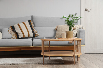 Poster - Interior of light living room with grey sofa and table